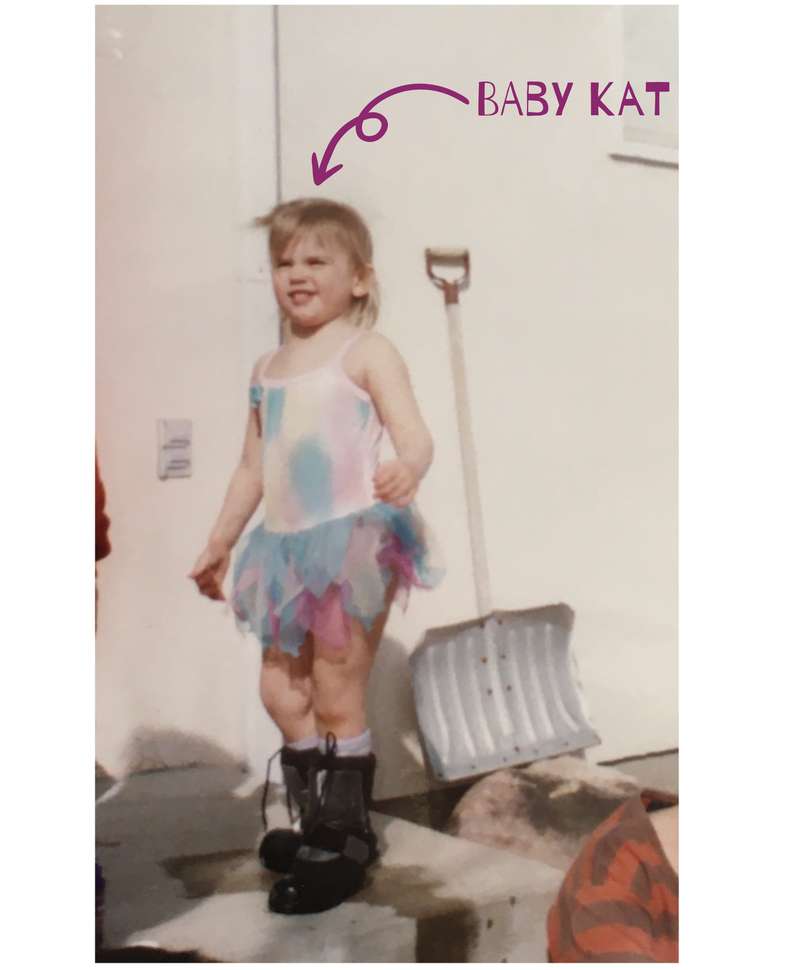 Young Kat stands squinting in the sun on a front stoop, wearing big black boots and a pink, purple, and blue leotard with a tutu. A snow shovel sits behind them, and an arrow points to their face labeled “baby Kat.”