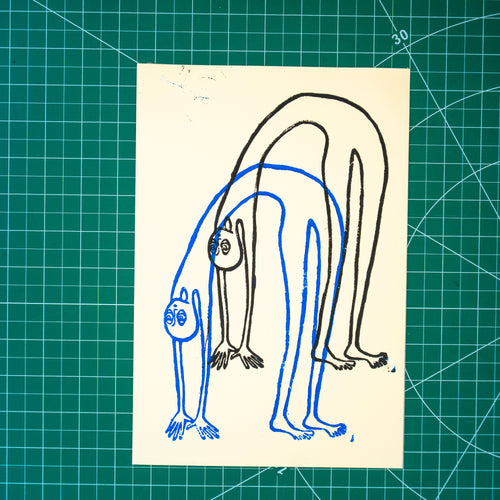 A rectangular art print featuring layered linocut design of a figure in a backbend in blue and black ink. Displayed on green cutting mat with grid lines.