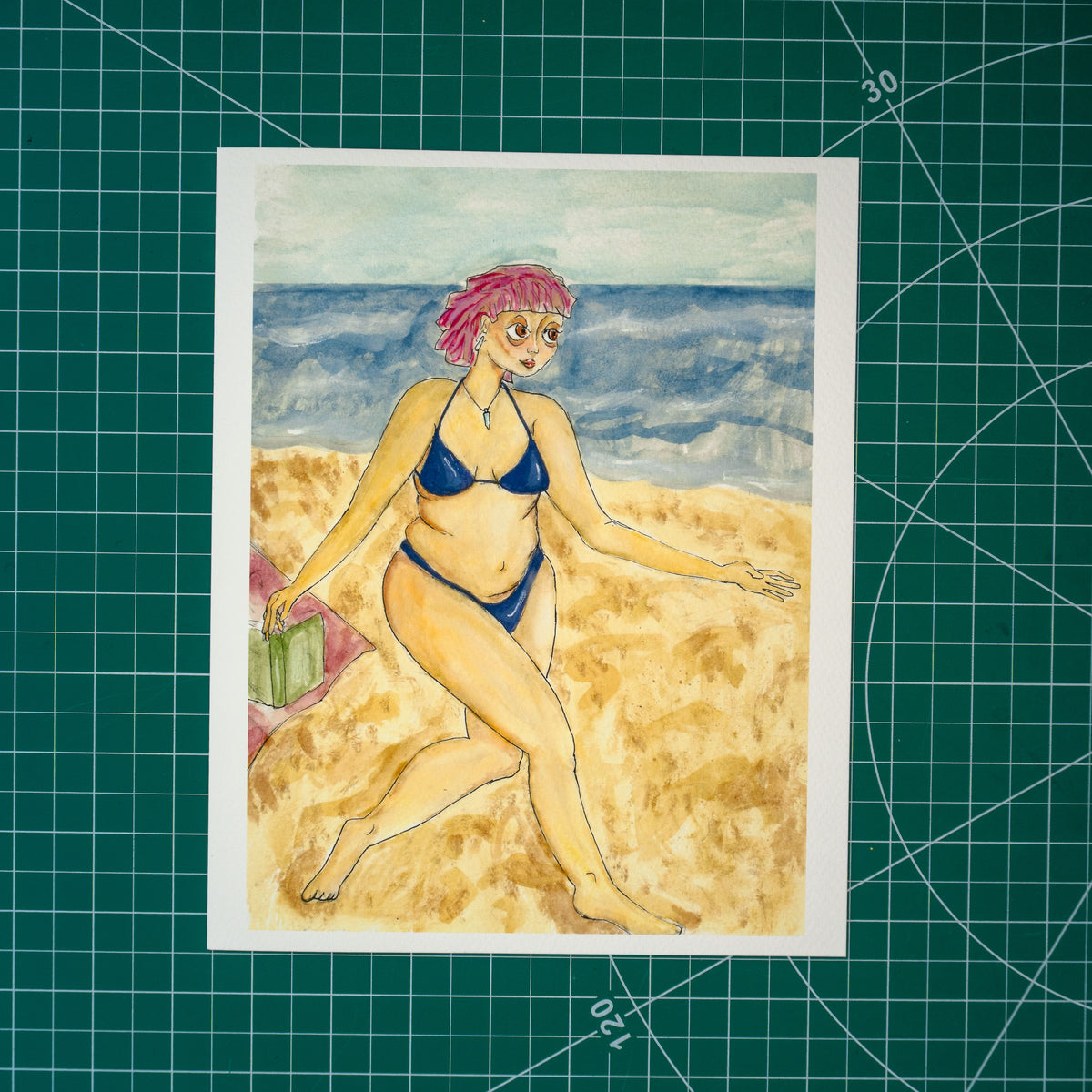 Gouache and watercolor painting of a person frolicking on a beach. They smile broadly, with pink hair and a purple bikini. Behind them are the ocean and a towel with a book resting on it.