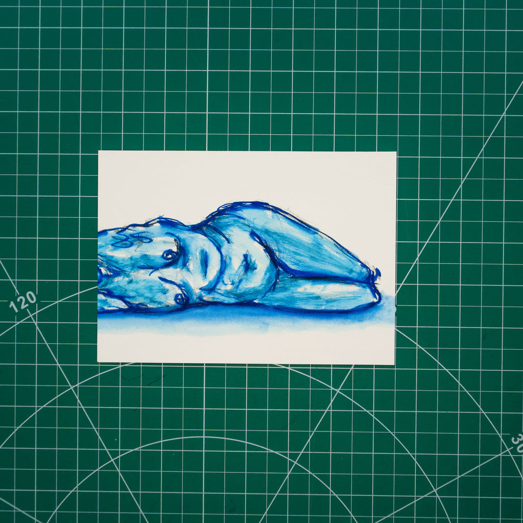 Watercolor composition of a figure lying down with their head just out of frame. The body is rendered in loose brushstrokes, with shadows and highlights formed through layered washes of blue.