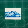 Watercolor composition of a figure lying down with their head just out of frame. The body is rendered in loose brushstrokes, with shadows and highlights formed through layered washes of blue.