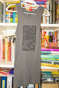 A gray sleeveless tank top with a black linocut flower design hanging on a white hanger in front of a bookshelf filled with books.
